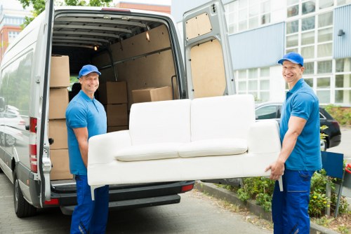 Packed moving boxes and furniture in a Portuguese apartment relocation
