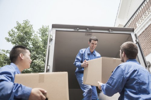 Packed moving boxes and furniture loaded for transport in Portugal